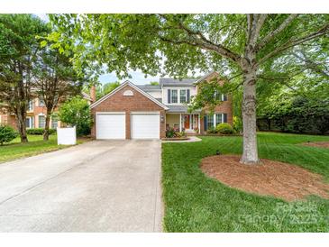 Charming two-story brick and siding home with a well-manicured lawn and a two-car garage at 1916 Pine Mountain Rd, Charlotte, NC 28214