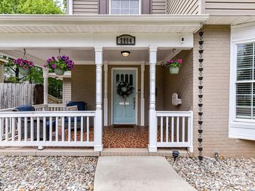 Inviting front porch with decorative hanging plants and a charming, painted front door at 2804 Park Rd, Charlotte, NC 28209