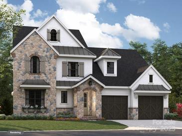 Charming two-story home with stone accents, a well-maintained lawn, and a three-car garage at 4015 Pritchard Pl, Fort Mill, SC 29715