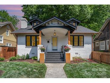 Charming renovated two-story home featuring a freshly painted white brick exterior and inviting front porch at 624 Oakland Ave, Charlotte, NC 28204