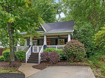Charming home featuring a welcoming porch, manicured landscaping, and a blend of natural beauty and curb appeal at 716 Ellsworth Rd, Charlotte, NC 28211