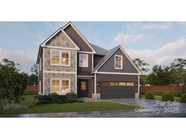 Charming two-story home featuring stone accents, gray siding, a two-car garage, and a well-maintained front yard at Lot 2 Henderson Cir, Harrisburg, NC 28075