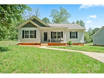Charming one-story home with black shutters and inviting front porch on a sunny day at 1013 Old Charlotte Rd, Statesville, NC 28677