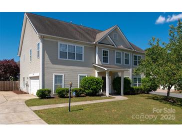 Charming two-story home with well-maintained lawn and lush landscaping offers great curb appeal at 12802 Waterlyn Club Dr, Charlotte, NC 28278
