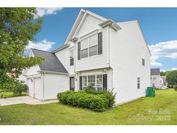 Charming two-story home featuring white siding, black shutters, and a well-maintained front lawn at 3038 Old Ironside Dr, Charlotte, NC 28213