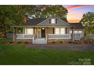 Charming home with a welcoming front porch and well-maintained landscaping at 319 N Central Ave, Locust, NC 28097