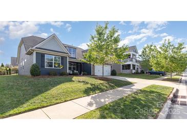 Charming home with a two-car garage, well-manicured lawn and inviting front porch perfect for relaxing at 3267 Lock Erne Ave, Kannapolis, NC 28081