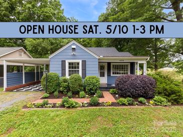 Charming blue home with lush landscaping and a well-manicured front yard, with an open house banner displayed above at 430 Sells Rd, Salisbury, NC 28144