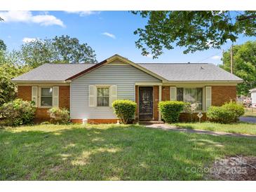 Charming single-story home with brick and siding exterior, manicured bushes, and a well-kept lawn at 728 Dedmon Dr, Charlotte, NC 28216
