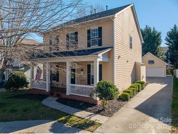 Charming two-story home featuring a welcoming front porch and meticulously maintained landscaping at 8532 Westmoreland Lake Dr, Cornelius, NC 28031