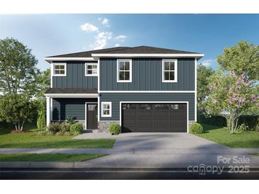 Charming two-story home featuring a well-manicured lawn, gray siding, and an attached two-car garage at Lot 39 Swallow Tail Ln, Kannapolis, NC 28083