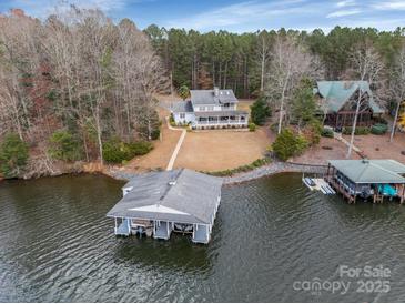 Stunning lakefront property with a private boathouse and beautifully landscaped grounds at 192 Diana Dr, Mount Gilead, NC 27306