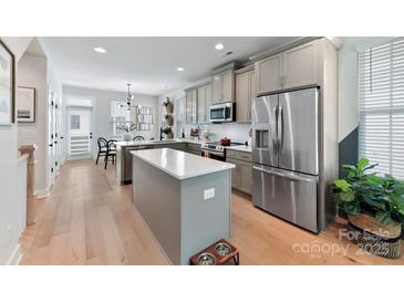Bright kitchen with stainless steel appliances, kitchen island and an adjacent dining area at 316 S Turner Ave # 11, Charlotte, NC 28208