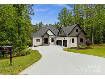 Stunning exterior of a modern two-story home with a long driveway and three-car garage at 4135 Mineral Ln, Lincolnton, NC 28092
