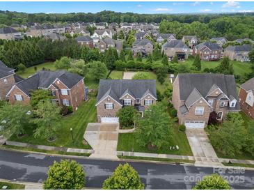 Beautiful brick home featuring a well-manicured lawn and a two-car garage in a quiet neighborhood at 422 Deer Brush Ln, Waxhaw, NC 28173