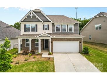 Charming two-story home featuring a brick and siding exterior, attached two car garage, and landscaped front yard at 423 Shallowford Dr, Rock Hill, SC 29732