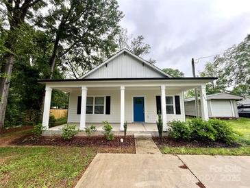 Charming home featuring a welcoming porch with white columns and a vibrant blue front door at 514 Rich St, Rock Hill, SC 29730
