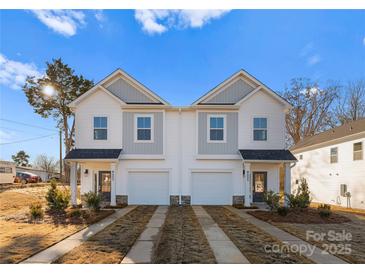 New construction townhomes showcase modern architectural details, attached garages, and landscaped front yards on a sunny day at 9715 Misenheimer Rd # 4B, Charlotte, NC 28215