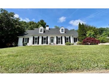 Charming single story home with black shutters, dormers and mature landscaping at 208 Armstrong Dr, Belmont, NC 28012