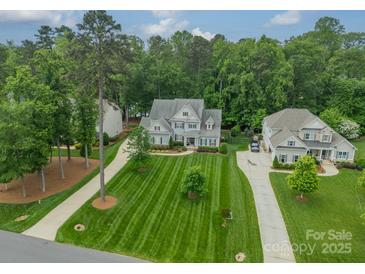 Stunning aerial view of a luxurious home featuring lush landscaping and a long driveway at 212 Seven Oaks Lndg, Belmont, NC 28012