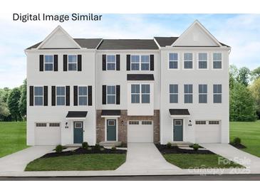 Beautiful townhome exteriors featuring light siding, black shutters, and professionally landscaped lawns at 2520 Ellen Ave # 1001C, Charlotte, NC 28208