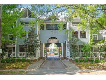 Charming condo complex entrance with brick-paved driveway and manicured landscaping at 300 E Park Ave # 16, Charlotte, NC 28203