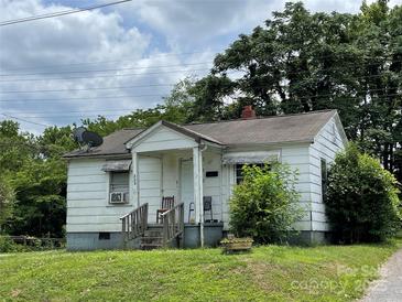 Charming single-story home with a cozy front porch and a well-maintained lawn at 302 Melrose Sw Dr, Concord, NC 28025
