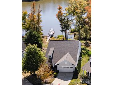 Charming home with a two-car garage and beautiful landscaping, situated near a serene lake and dock at 31226 Cove View Ct, Lancaster, SC 29720