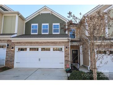 Charming two-story home featuring a stone facade, a two-car garage, and a well-manicured lawn at 5063 Gribble Ln, Lancaster, SC 29720