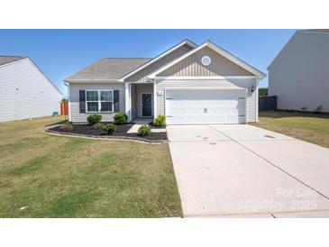 Charming single-story home with well-maintained lawn, tidy landscaping, and a two-car garage on a sunny day at 6719 Jerimoth Dr, Charlotte, NC 28215