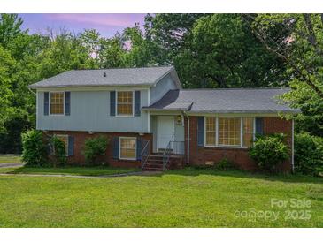 Charming two-story home with brick and vinyl siding and mature landscaping at 7106 Marlbrook Dr, Charlotte, NC 28212
