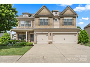 Attractive two-story home with a two car garage, stone accents, and well-maintained landscaping at 1011 Potomac Rd, Indian Trail, NC 28079