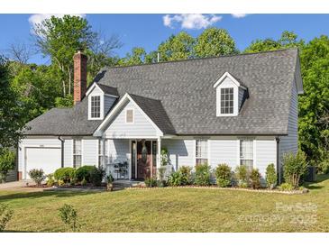 Charming single Gathering home featuring a manicured front lawn, brick chimney, and inviting front porch at 3223 Rheinwood Ct, Matthews, NC 28105