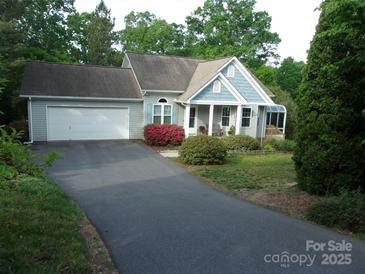 Charming single-story home with a long drive, attached garage, and inviting covered front porch at 109 Gatwick Ct, Statesville, NC 28677