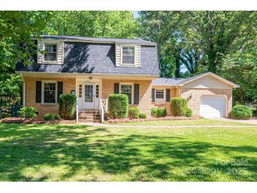 Charming brick home featuring a manicured lawn and beautiful landscaping at 1324 Princeton Ave, Gastonia, NC 28054