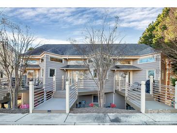 Exterior view of townhomes with multiple decks and well-maintained landscaping at 13932 Queens Harbor Rd, Charlotte, NC 28278