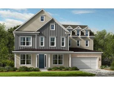 Charming two-story home with a manicured lawn, a mix of horizontal and vertical siding, and a two-car garage at 153 Glenn Dr, Mooresville, NC 28115