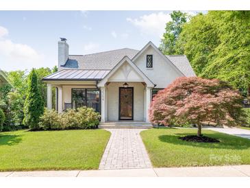 Charming home featuring a manicured lawn, walkway, light brick, mature landscaping, and a striking Japanese Maple at 2304 Commonwealth Ave, Charlotte, NC 28205