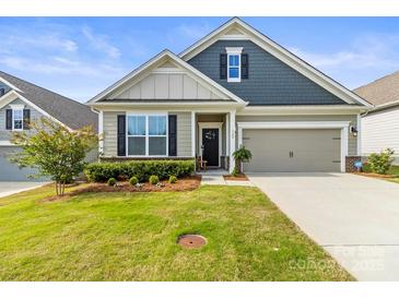 Charming single-Gathering home featuring manicured lawn, neutral colors, and a two-car garage at 329 Secretariat Dr, Iron Station, NC 28080