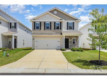 Charming two-story home with a two-car garage, well-manicured lawn and neutral color palette at 4009 Stoneygreen Ln, Charlotte, NC 28215