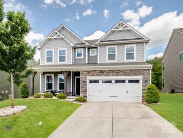 Charming two-story home with stone accents, lush lawn and a spacious two car garage at 4316 Falls Lake Sw Dr, Concord, NC 28025