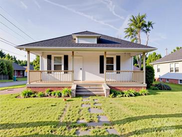 Charming home featuring a inviting front porch, manicured lawn, and pathway at 55 Ranlo Ave, Gastonia, NC 28054