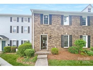 Charming brick townhome with black shutters and well-maintained landscaping, offering a welcoming curb appeal at 8049 Regent Park Ln, Charlotte, NC 28210