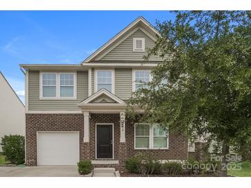 Charming two-story home featuring brick and siding, a front porch, and an attached garage at 838 Von Buren Blvd, Rock Hill, SC 29730