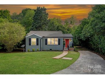 Charming bungalow with a well-manicured lawn, a stone walkway, and a vibrant red front door at 1100 Mona Dr, Charlotte, NC 28206