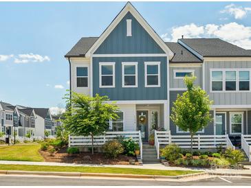 Charming townhome with blue siding, a cozy porch, and well-maintained landscaping at 119 Berkeley Ave # A, Mooresville, NC 28117