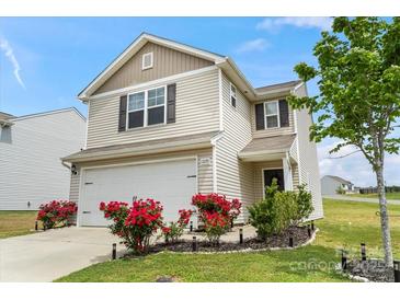Charming two-story home with a manicured lawn, a two-car garage, and beautiful red roses at 1270 Winding Creek Rd, Salisbury, NC 28146