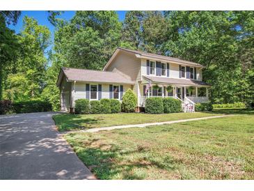 Charming two-story home with a well-manicured lawn, front porch, and lush landscaping at 335 Bob White Run, Salisbury, NC 28147
