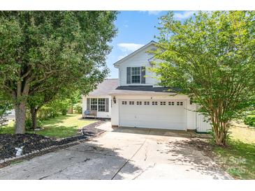 Charming two-story home with a well-maintained lawn, featuring a two-car garage and classic white siding at 4002 Solomons Ct, Monroe, NC 28110