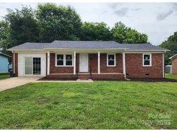 Charming single story brick home with a well-maintained lawn and inviting front porch at 409 S Martin Luther King Jr Ave, Salisbury, NC 28144
